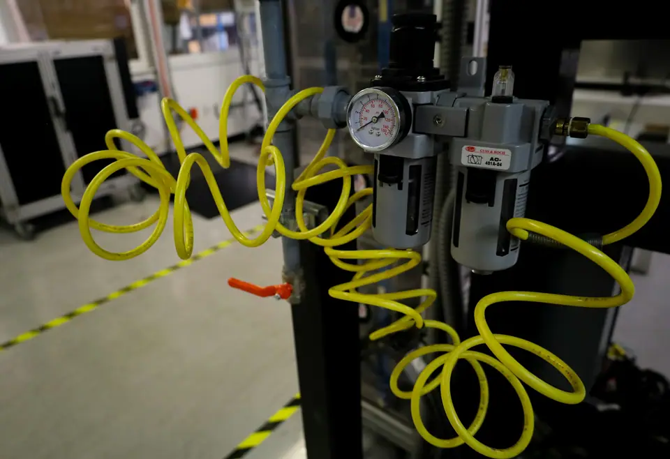 Filter regulator units with pressure gauges and yellow coiled air hose