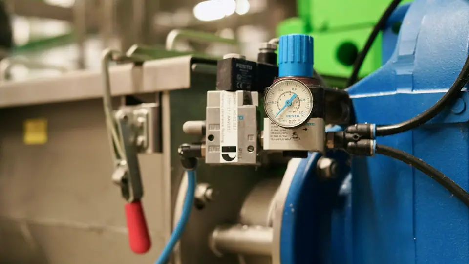 Solenoid valve and regulator mounted on a machine